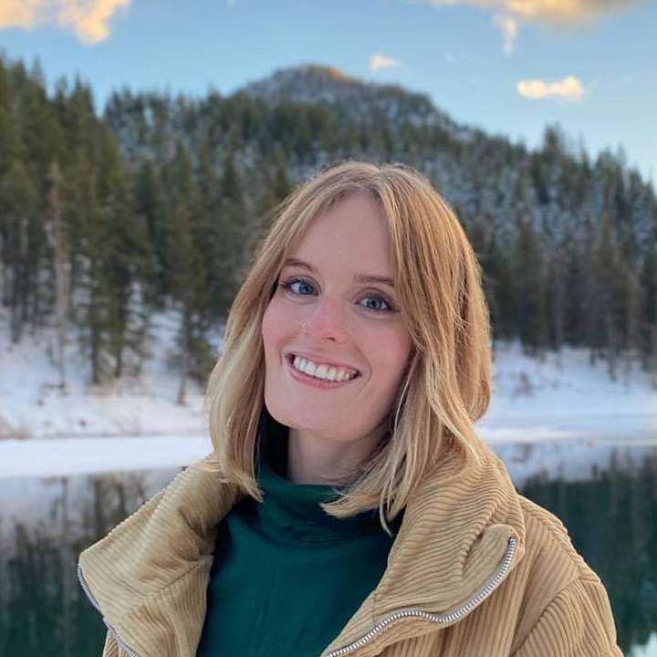 Biology alum Eden Brush in front of snow-covered lake