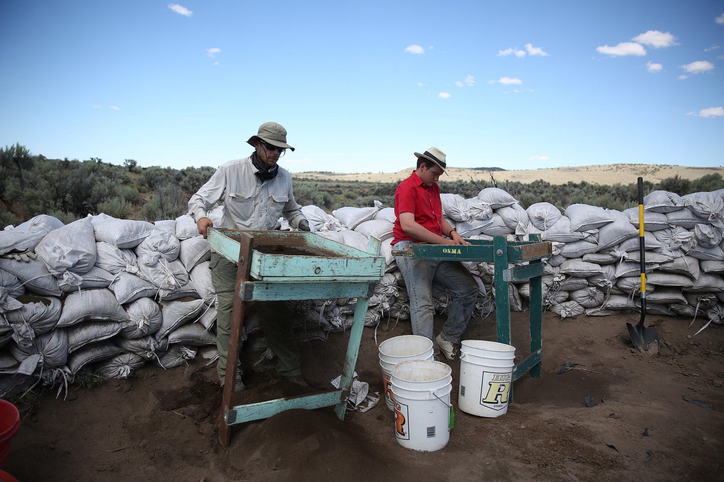 student and professor doing field work on location