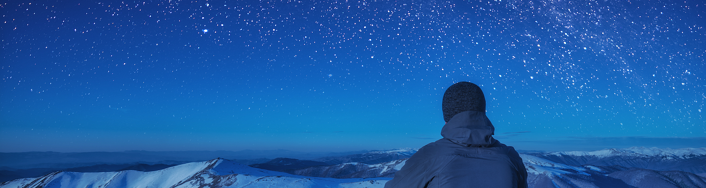 A climber sitting on a ground at night