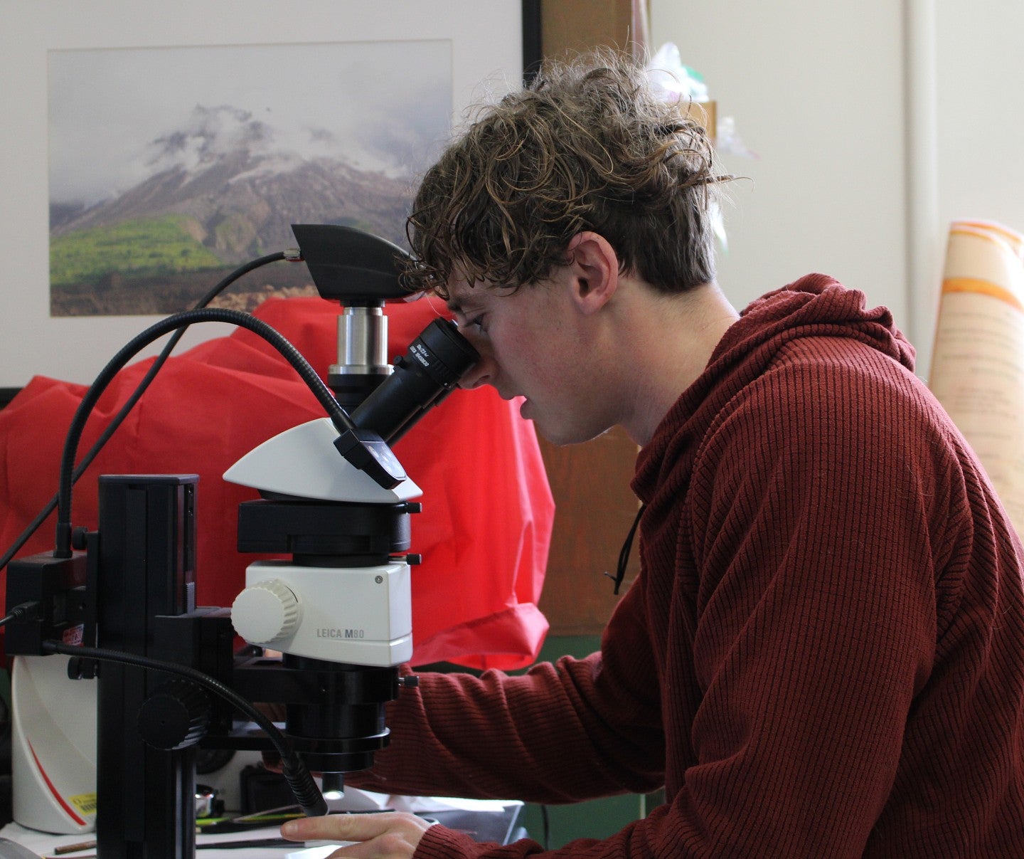 Student looking through a microscope in a lab