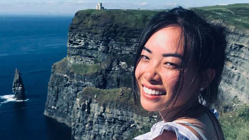 student standing near cliffs in Ireland