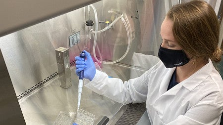 Caitlin Kowalski drops liquid into a beaker