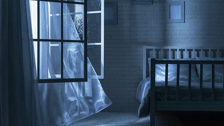 A bedroom with the windows open