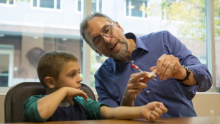 Brendan Bohannan talks to a child participant about the study