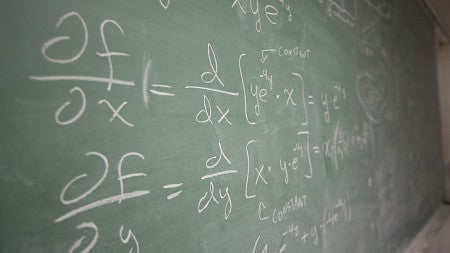 chalkboard with math equations written on it