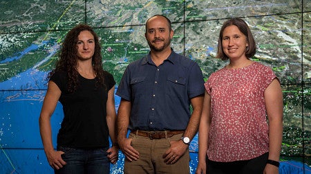 CRESCENT PIs pose in front of a map