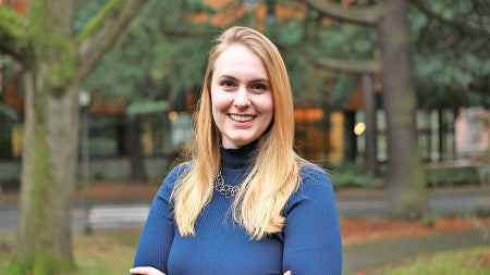 a smiling person wearing a blue shirt