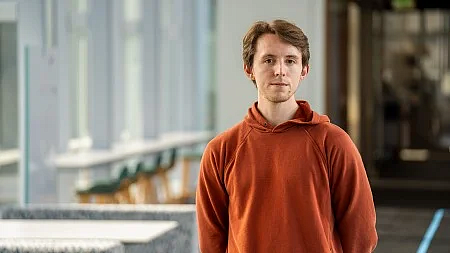 person wearing a rust-colored sweatshirt