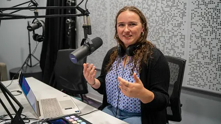 a student speaks into a microphone