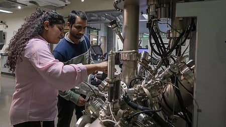 two people working near a microscope