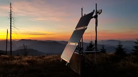 a solar panel in front of a sunset