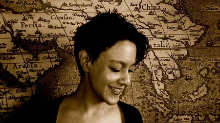 Smiling woman in front of a map