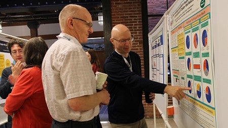 Two men looking at a research poster