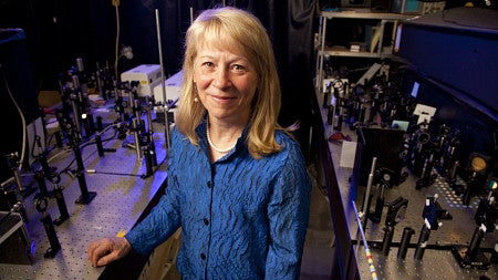 smiling person standing in a laboratory