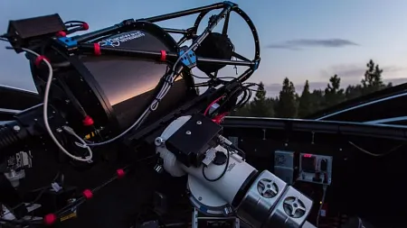 a telescope pointed toward the dusk sky