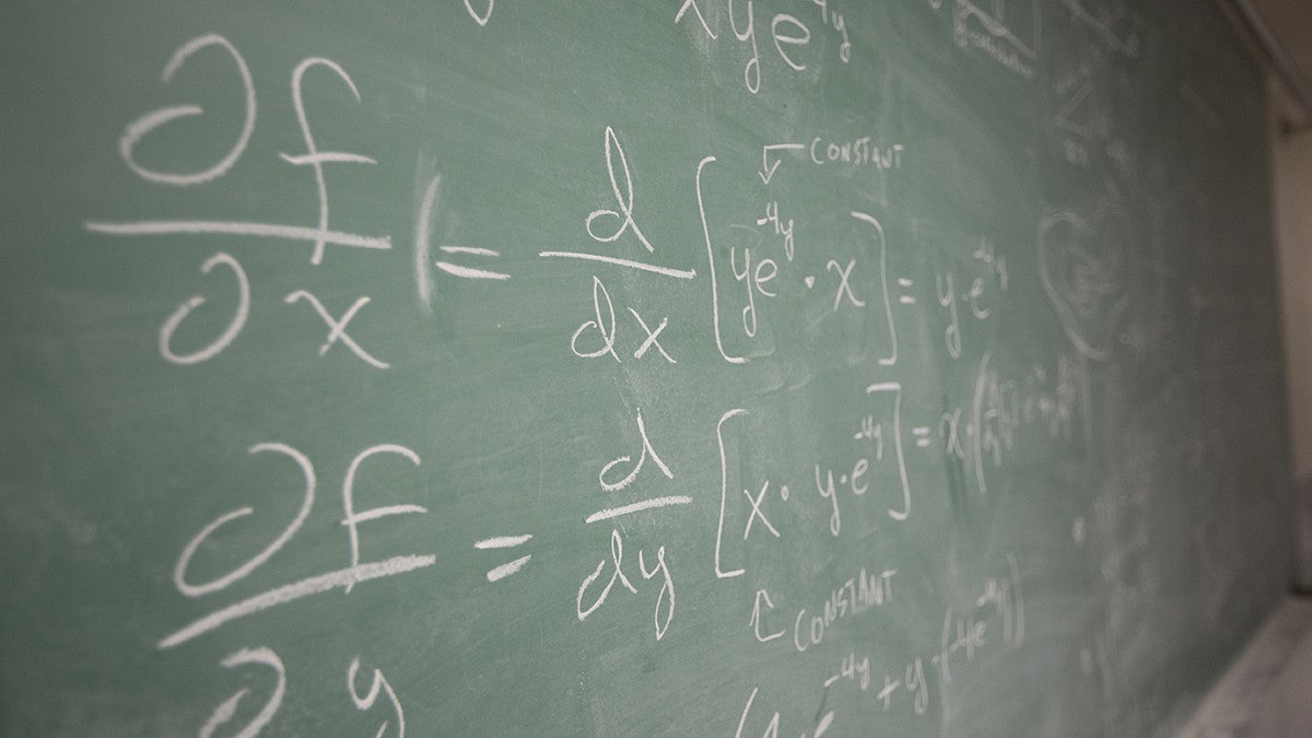 chalkboard with math equations written on it