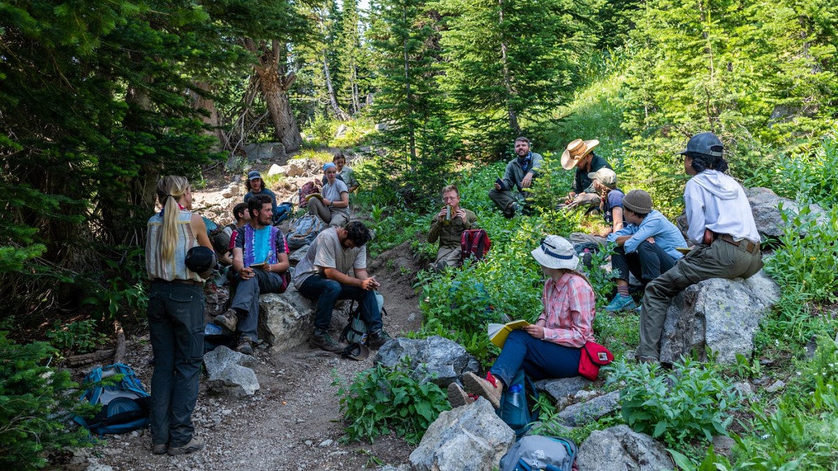 Group of students sitting on a trail