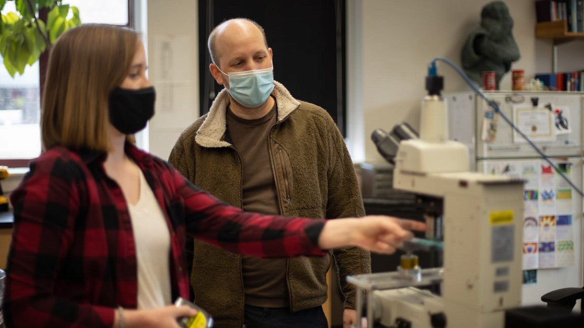 Student explaining work in a lab