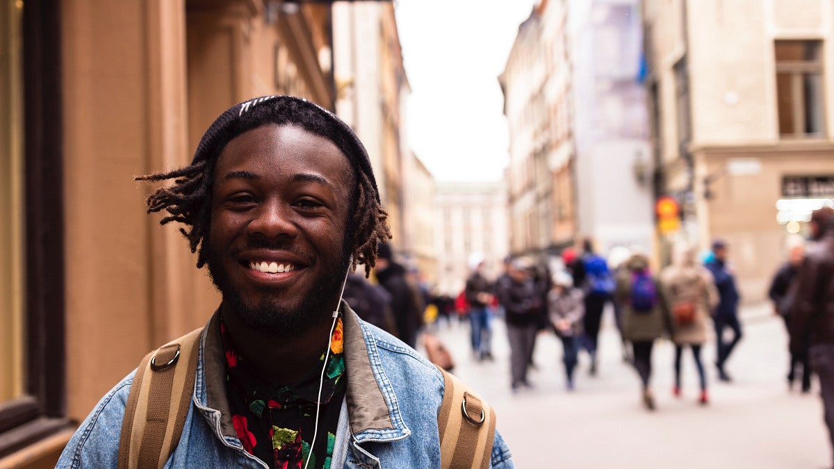 Student walking down the street in another country