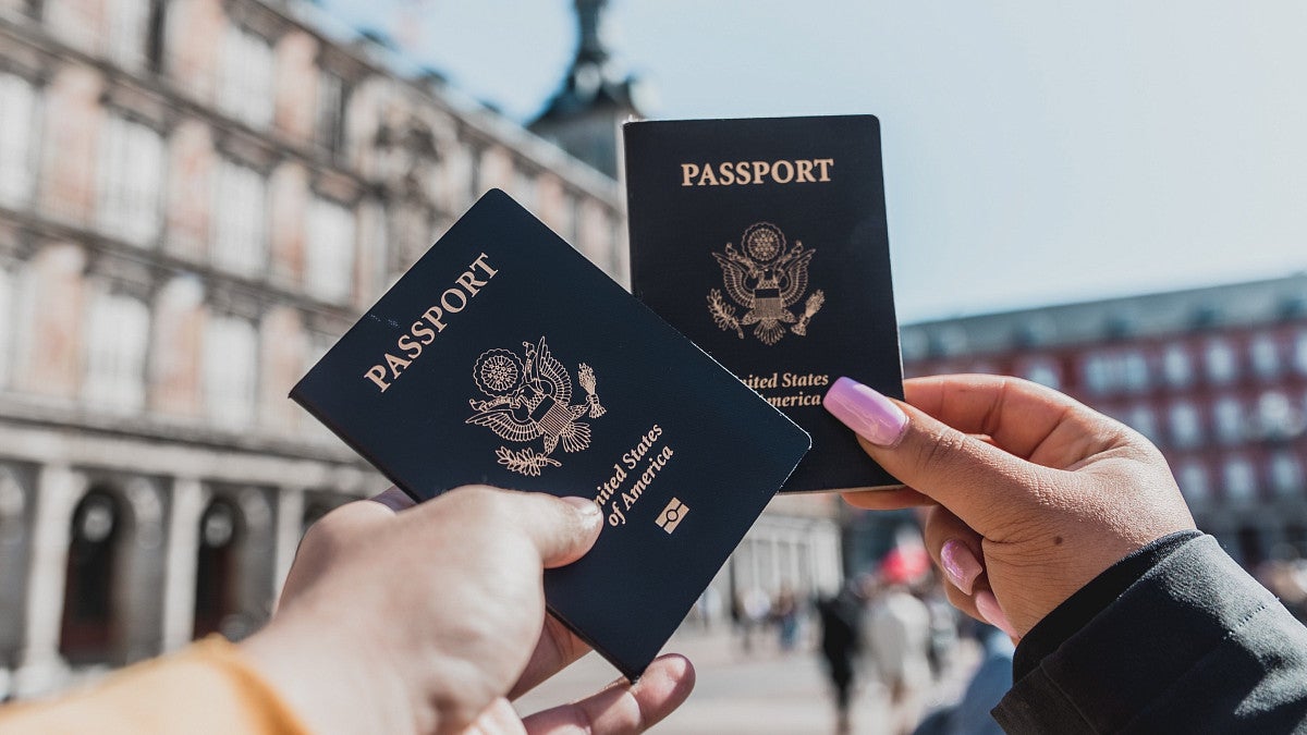 Students holding up their passports