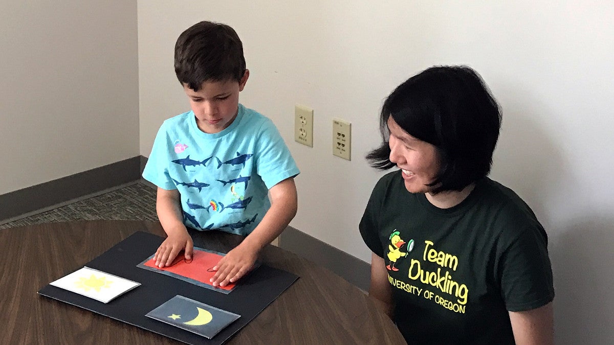 Psychology student working with a child