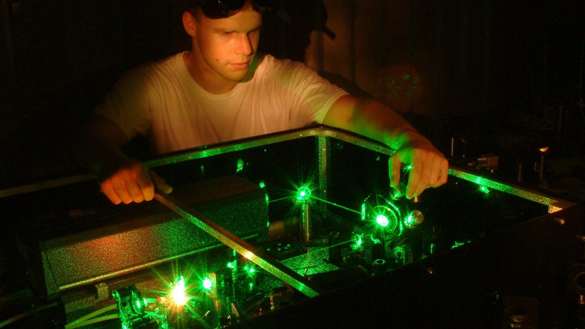 Student operating equipment in a chemistry lab