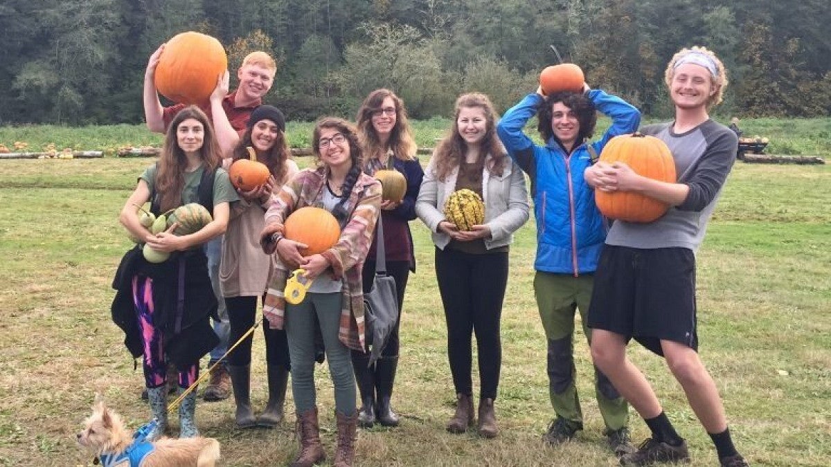 OMSA members posing for a group photo while holding pumpkins