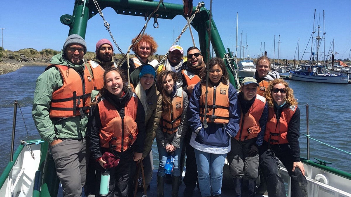 OIMB students in a group photo standing on a research boat