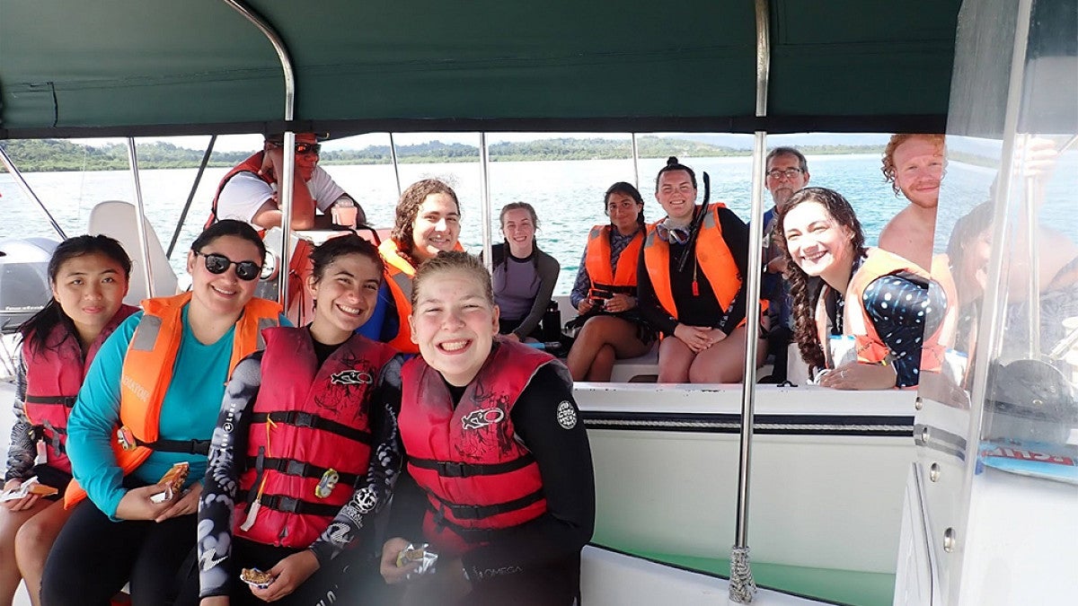 Group of marine biology students riding on a boat