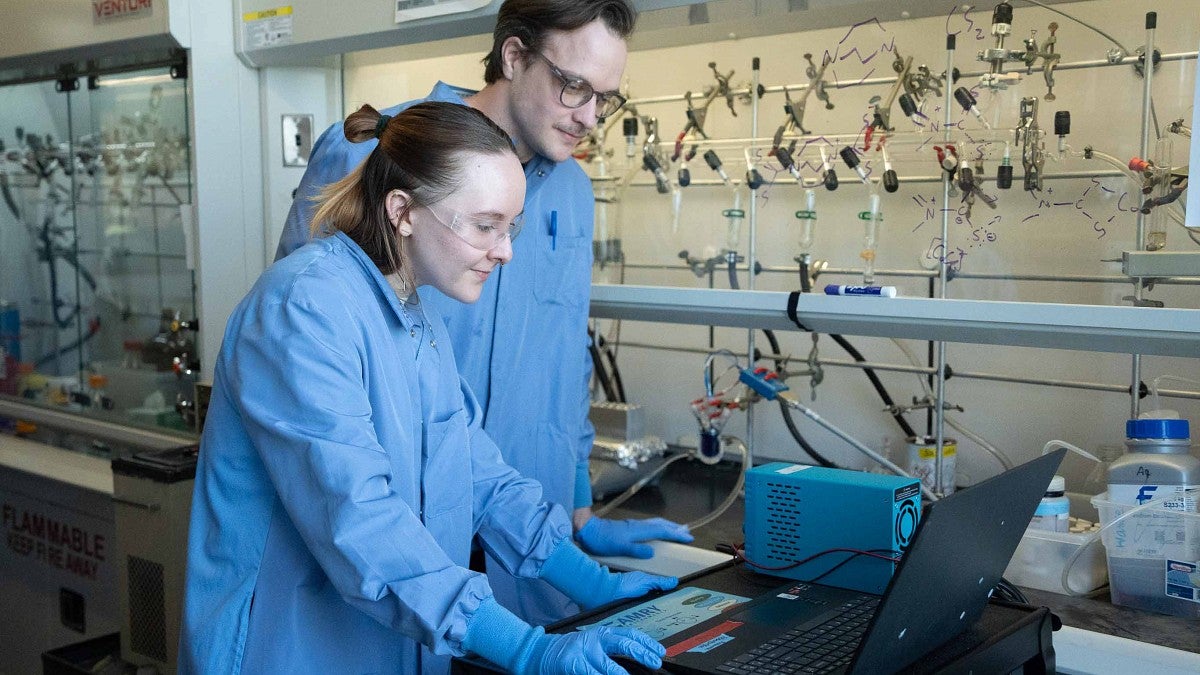 Two people in a lab looking at a computer
