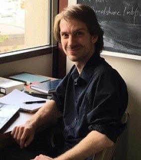 man sitting in front of a window