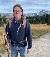 a person hiking on a mountain trail
