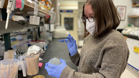 A researcher handles a beaker 