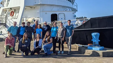 faculty and students with the research vessel Oceanus