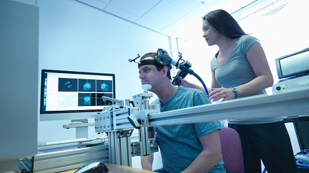 people in lab measuring brain activity with headset