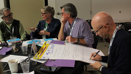 Participants discuss and take notes during a breakout session at a CRESCENT workshop.
