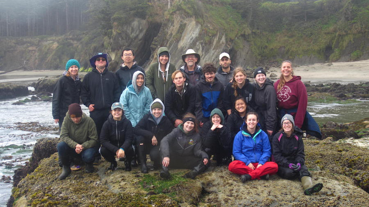 marine biology student group shot on rocky shore