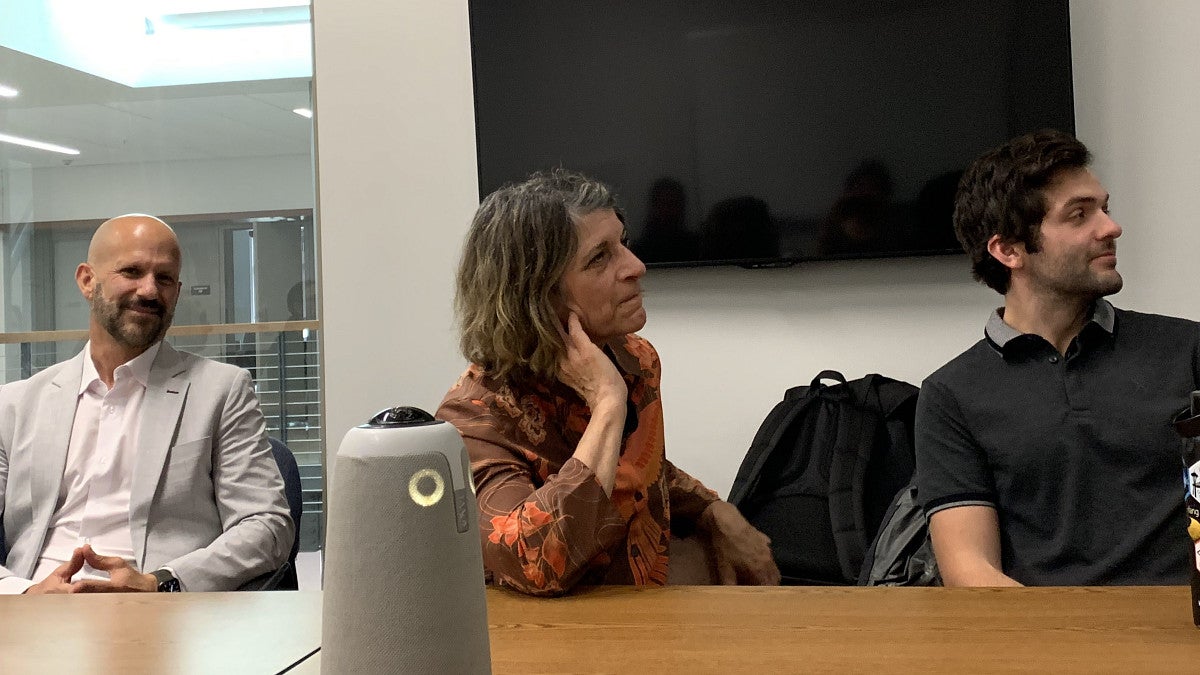 Psychology faculty and graduate students sitting at a table