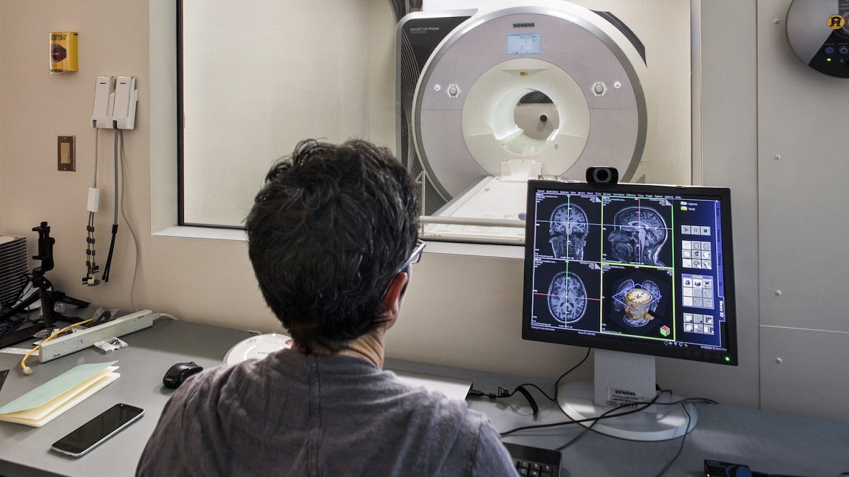 Lab technician examining an MRI brain scan